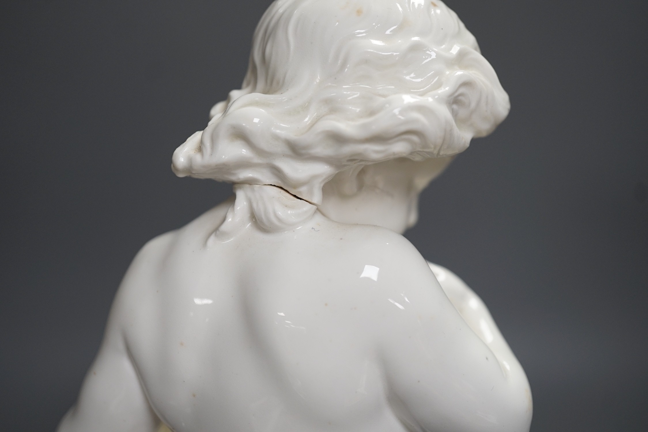 A Copeland porcelain putti seated on a shell centrepiece, modelled by O. Hale, c.1877, 35cms high